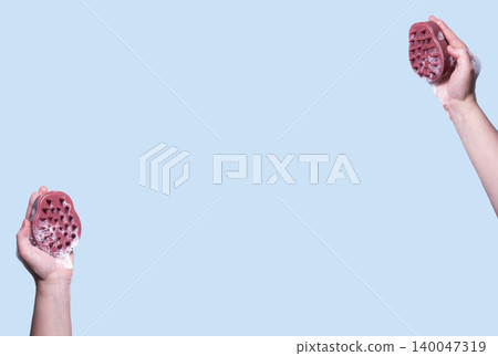 Hair brush for stimulating hair growth on blue background. Microcirculation, help to distribute natural oils more evenly across the scalp 140047319