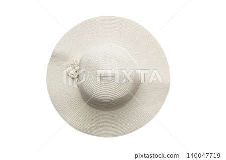 Close-up photo of a wide-brimmed woven straw hat in light beige color with a decorative braided flower detail near the crown. Close-up photo of a wide-brimmed woven straw hat in light beige color with a decorative braided flower detail near the crown. 140047719