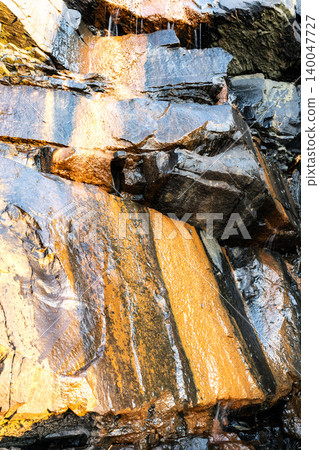 The Nichinan Formation illuminated by the morning sun at the descent point from the Inozakibana Park Campground in Nichinan City, Miyazaki Prefecture, to the rocky area. The Nichinan Formation illuminated by the morning sun at the descent point from the Inozakibana Park Campground in Nichinan City, Miyazaki Prefecture, to the rocky area. 140047727