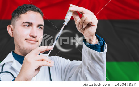 Doctor holding syringe on Libya flag background. Medical professional holding syringe with Libyan flag in the background Doctor holding syringe on Libya flag background. Medical professional holding syringe with Libyan flag in the background 140047857