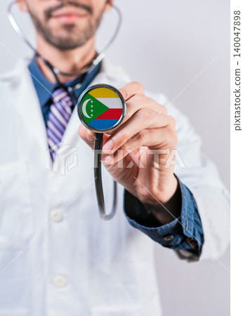 Comoros health and medical insurance concept. Comoros healthcare system, doctor holding stethoscope Comoros health and medical insurance concept. Comoros healthcare system, doctor holding stethoscope 140047898