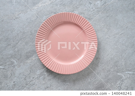 Empty pink ceramic plate on gray stone background with copy space Empty pink ceramic plate on gray stone background with copy space 140048241