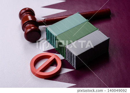 The cargo container ban on the Qatar flag as a conceptual backdrop. The cargo container embargo The cargo container ban on the Qatar flag as a conceptual backdrop. The cargo container embargo 140049092