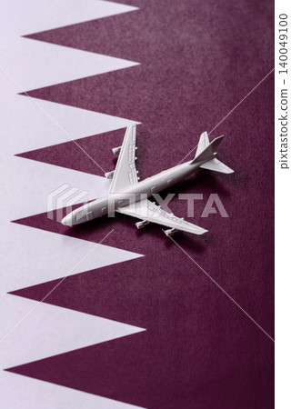 An airplane on the Qatari flag as a conceptual backdrop for flights . An airplane on the Qatari flag 140049100