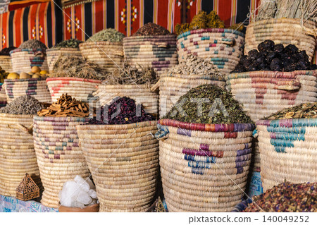 Herbal teas spices and dried medicinal herbs in woven baskets at Egyptian market stall Herbal teas spices and dried medicinal herbs in woven baskets at Egyptian market stall 140049252