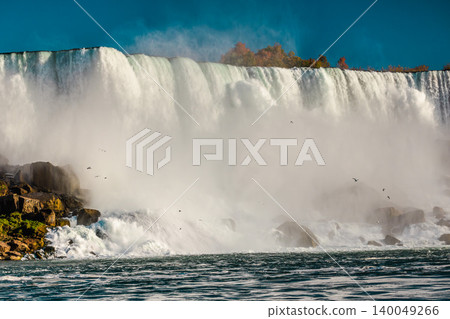 Niagara Falls powerful waterfall with mist clouds and rushing water at autumn landscape Niagara Falls powerful waterfall with mist clouds and rushing water at autumn landscape 140049266