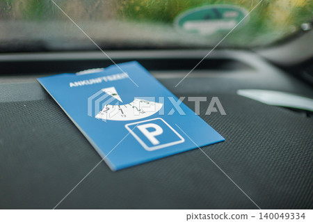 European parking disc placed on car dashboard for timed parking zone European parking disc placed on car dashboard for timed parking zone 140049334