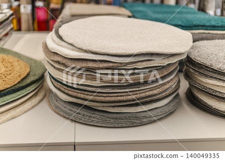 Stacked round chair cushions and soft textile pads in home improvement store Stacked round chair cushions and soft textile pads in home improvement store 140049335