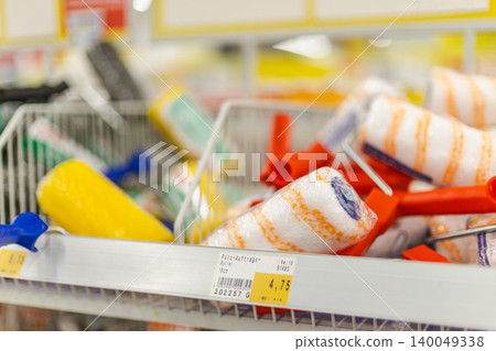 Painting rollers and DIY renovation accessories arranged on retail shelf in hardware shop Painting rollers and DIY renovation accessories arranged on retail shelf in hardware shop 140049338