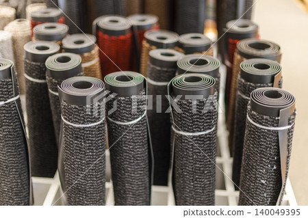 Rolled entrance floor mats and carpet runners in retail home improvement store Rolled entrance floor mats and carpet runners in retail home improvement store 140049395