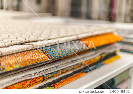 Stack of colorful carpet samples and decorative rugs in home improvement store Stack of colorful carpet samples and decorative rugs in home improvement store 140049401