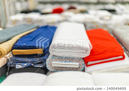 Colorful folded textile materials and fabric rolls in retail store display Colorful folded textile materials and fabric rolls in retail store display 140049409
