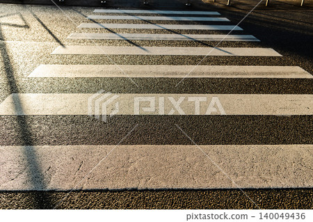 Pedestrian zebra crossing with white stripes on asphalt road in German city street Pedestrian zebra crossing with white stripes on asphalt road in German city street 140049436