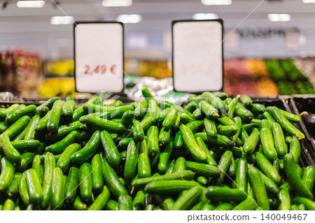 Fresh cucumbers with price signs in supermarket produce aisle showing healthy vegetables and grocery shopping concept Fresh cucumbers with price signs in supermarket produce aisle showing healthy vegetables and grocery shopping concept 140049467