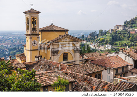 Historic Santa Grata Inter Vites church and tiled rooftops in Bergamo Citta Alta with panoramic hillside view in Italy travel destination Historic Santa Grata Inter Vites church and tiled rooftops in Bergamo Citta Alta with panoramic hillside view in Italy travel destination 140049520