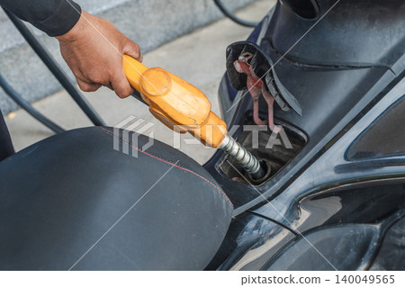 Refueling scooter with gasoline at fuel station close up Refueling scooter with gasoline at fuel station close up 140049565