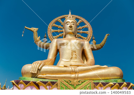 Golden Big Buddha statue at Wat Phra Yai temple on Koh Samui island in Thailand against blue sky Golden Big Buddha statue at Wat Phra Yai temple on Koh Samui island in Thailand against blue sky 140049583