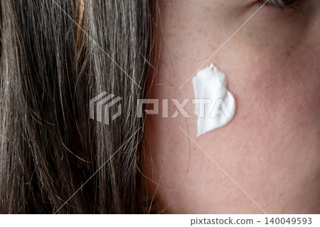 Girl with moistening creme on the face. Skincare for health beautiful skin. Routine with lotion or spf creme. Girl with moistening creme on the face. Skincare for health beautiful skin. Routine with lotion or spf creme. 140049593