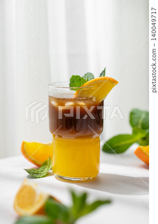 Cold bumble coffee with orange juice and ice on marble background 140049717