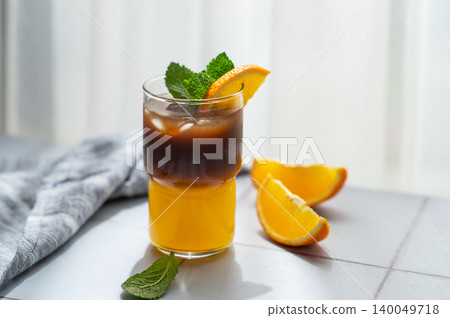 Cold bumble coffee with orange juice and ice on light background 140049718