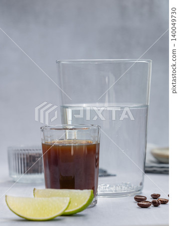 Coffee bomb with sparkling water and espresso shot, trendy summer coffee drink Coffee bomb with sparkling water and espresso shot, trendy summer coffee drink 140049730
