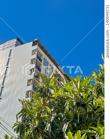 Modern high-rise residential buildings against a clear blue sky. 140049735