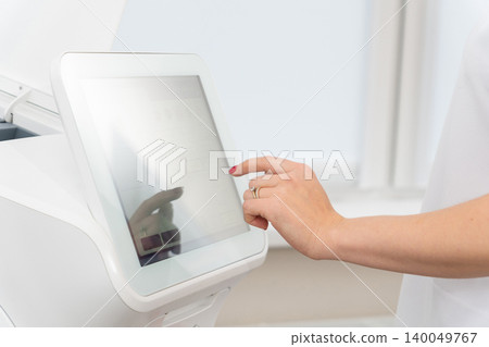 hand with red nails operating a touchscreen interface 140049767