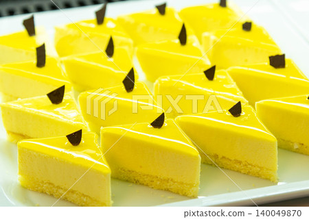 Individually packaged lemon cakes, yellow baked goods topped with chocolate chips. Individually packaged lemon cakes, yellow baked goods topped with chocolate chips. 140049870