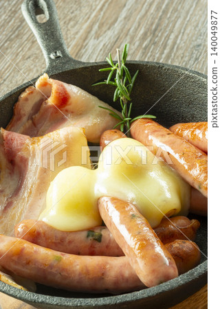 The sausages and cheese cooked in a skillet are exquisite, and the meat dish is infused with rosemary. The sausages and cheese cooked in a skillet are exquisite, and the meat dish is infused with rosemary. 140049877