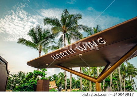 Entrance sign for the North Wing of the resort facility, located under the palm trees. 140049917