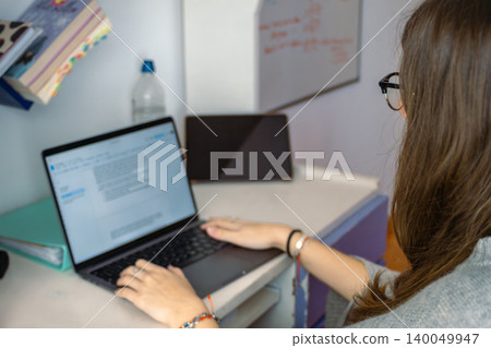 Student learning and working from home office using laptop Student learning and working from home office using laptop 140049947