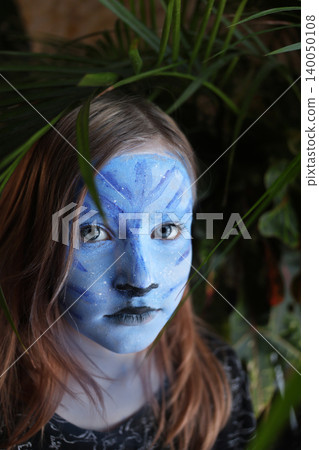 Master making aqua makeup. Face painting of a girl with a blue face. face painting kids child. Master making aqua makeup. Face painting of a girl with a blue face. face painting kids child. 140050108