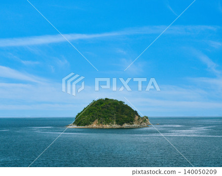 A deserted island floating in the blue sea and sky A deserted island floating in the blue sea and sky 140050209