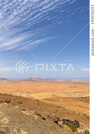 Wide view of Lanzarote desert landscape with volcanic hills and stark island beauty 140050261