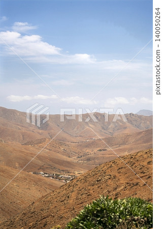 Wide view of Lanzarote desert landscape with volcanic hills and stark island beauty Wide view of Lanzarote desert landscape with volcanic hills and stark island beauty 140050264