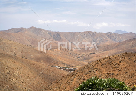 Wide view of Lanzarote desert landscape with volcanic hills and stark island beauty Wide view of Lanzarote desert landscape with volcanic hills and stark island beauty 140050267
