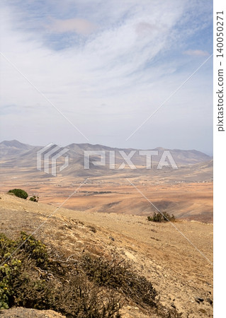 Wide view of Lanzarote desert landscape with volcanic hills and stark island beauty 140050271