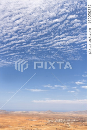 Wide view of Lanzarote desert landscape with volcanic hills and stark island beauty Wide view of Lanzarote desert landscape with volcanic hills and stark island beauty 140050282