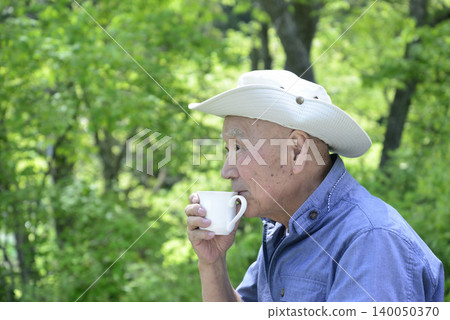 An elderly person living in the countryside enjoying forest bathing An elderly person living in the countryside enjoying forest bathing 140050370