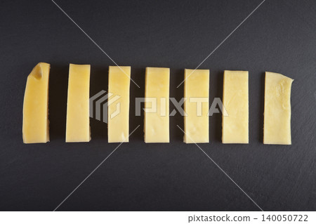 Cheddar cheese on a granite floor Cheddar cheese on a granite floor 140050722