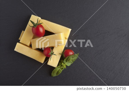 Cheddar cheese on a granite floor Cheddar cheese on a granite floor 140050730