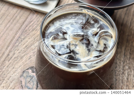 Iced coffee placed on a wooden table 140051464