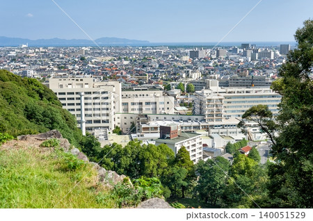 A view of Tottori University Hospital and the city of Yonago from near the stone walls of the castle keep at the Yonago Castle ruins (Yonago City, Tottori Prefecture). A view of Tottori University Hospital and the city of Yonago from near the stone walls of the castle keep at the Yonago Castle ruins (Yonago City, Tottori Prefecture). 140051529
