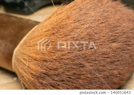 Macro view of soft makeup brush bristles showing detailed fiber texture warm brown tones cosmetic beauty tool surface for background design use Macro view of soft makeup brush bristles showing detailed fiber texture warm brown tones cosmetic beauty tool surface for background design use 140051643