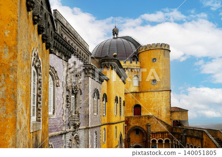 Colorful architectural facade and towers of Pena Palace under blue sky in Sintra, Portugal Colorful architectural facade and towers of Pena Palace under blue sky in Sintra, Portugal 140051805