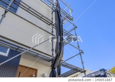 The exterior of the house after renovation, showing the new exterior walls and scaffolding. 140051887