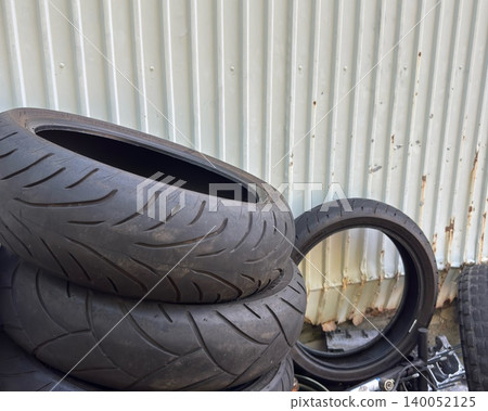 A stack of used motorcycle tires 140052125