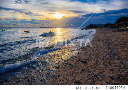 Samae Beach on Koh Lan, Chonburi, Thailand, is a beautiful beach at sunset, featuring a turtle-shaped building with a solar-powered roof. Samae Beach on Koh Lan, Chonburi, Thailand, is a beautiful beach at sunset, featuring a turtle-shaped building with a solar-powered roof. 140053054