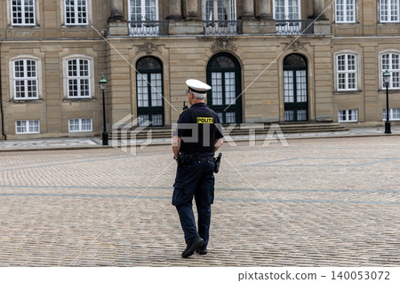 Danish police officer guarding Amalienborg Palace in Copenhagen, Denmark Danish police officer guarding Amalienborg Palace in Copenhagen, Denmark 140053072