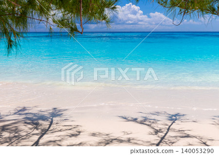 A beautiful beach with fine white sand and a bright blue sky, framed by tree branches and shadows, at Koh Tachai in the Similan Islands, Phang Nga, Thailand. A beautiful beach with fine white sand and a bright blue sky, framed by tree branches and shadows, at Koh Tachai in the Similan Islands, Phang Nga, Thailand. 140053290